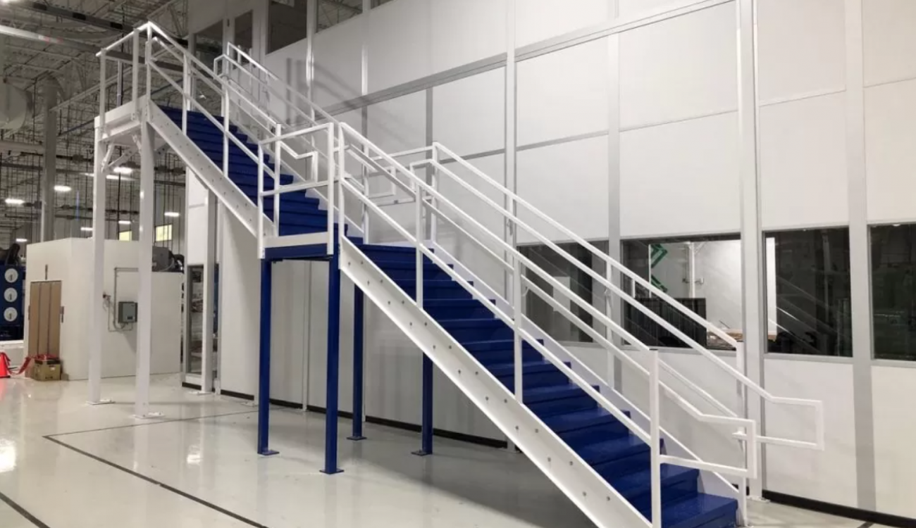 A two-level modular in-plant office with an exterior metal staircase.