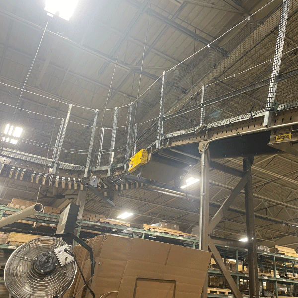 Netting added to overhead conveyor